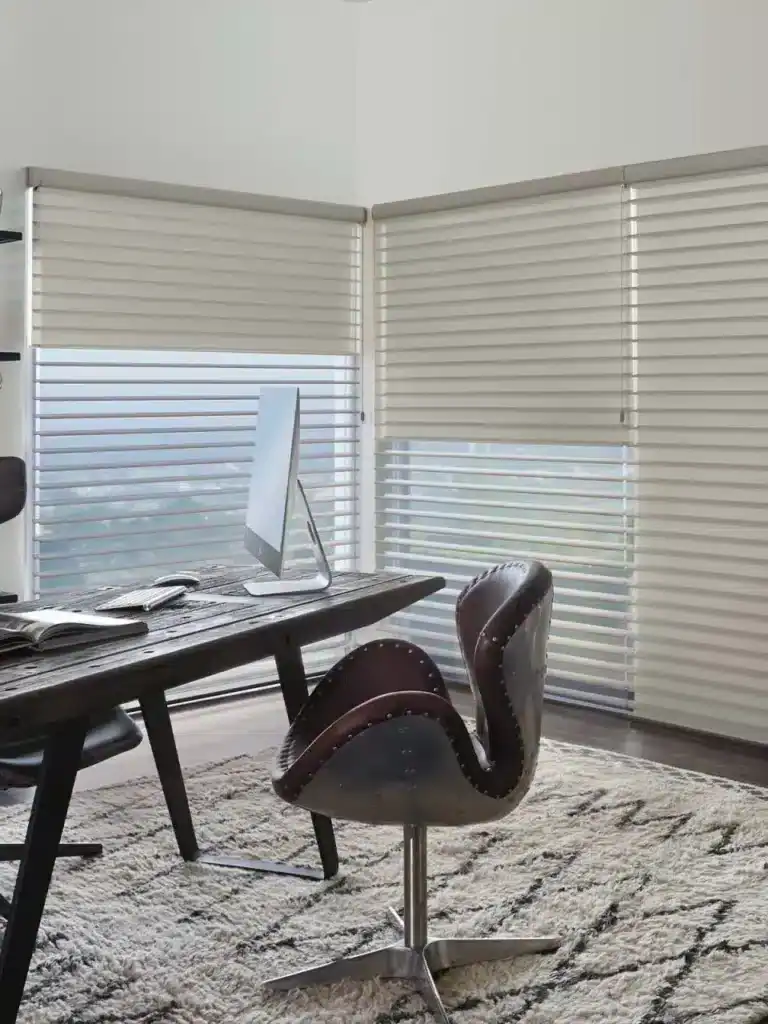 Spacious workspace with stylish wooden desk and ergonomic leather chair.