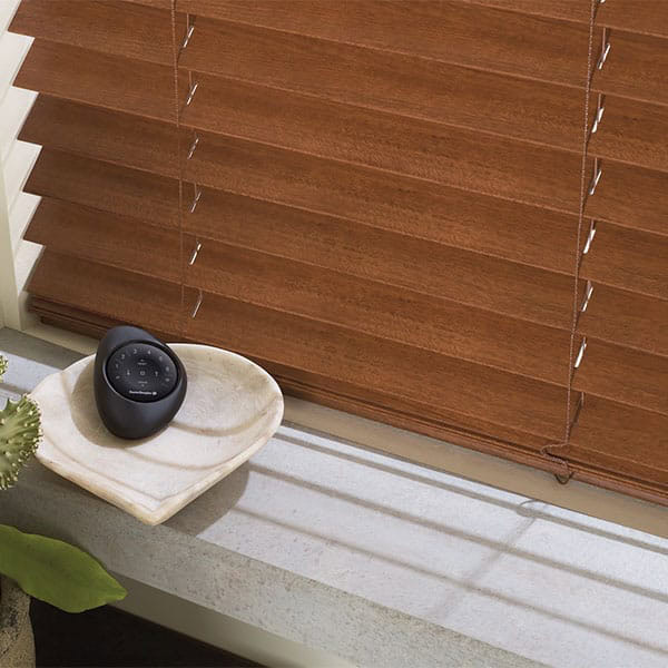 Highly customizable wooden window blinds with adjustable slats for optimal light and privacy management.