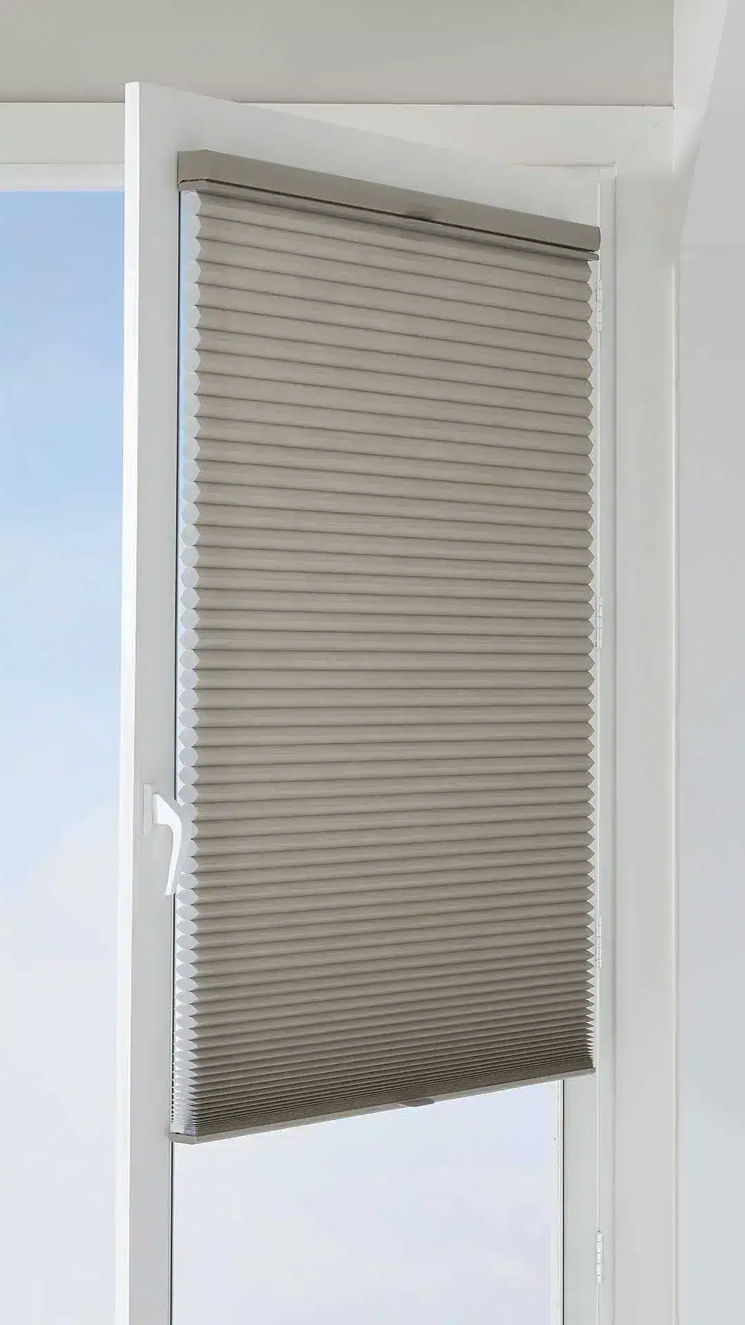 High-quality beige pleated window blind, perfect for enhancing interior décor while providing privacy and adjustable light filtering.