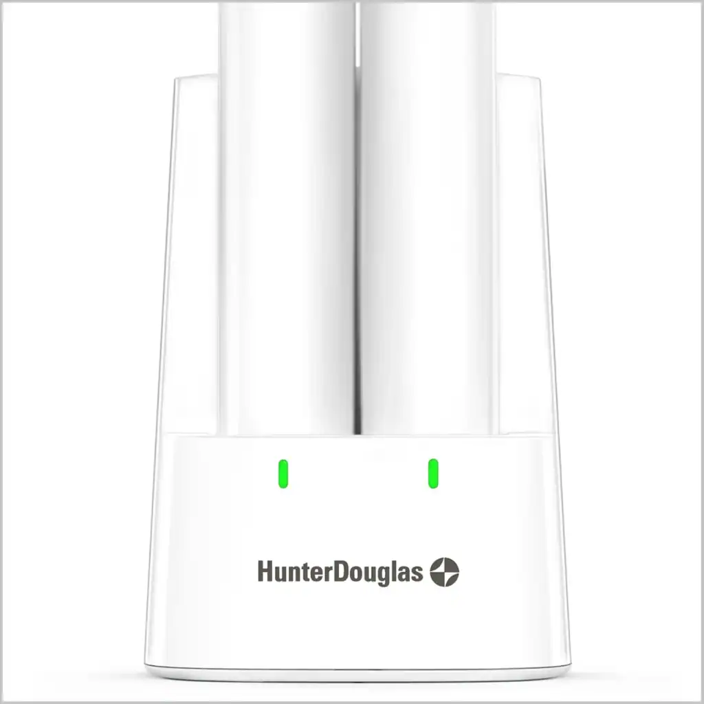 A sleek white dual slot toothbrush charger with green LED indicators, branded Hunter Douglas, designed for convenient and efficient charging of electric toothbrushes.