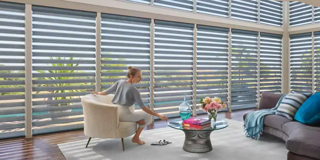 Bright contemporary living room featuring large horizontal blinds, cozy sofa, and elegant decor elements for relaxed living spaces.