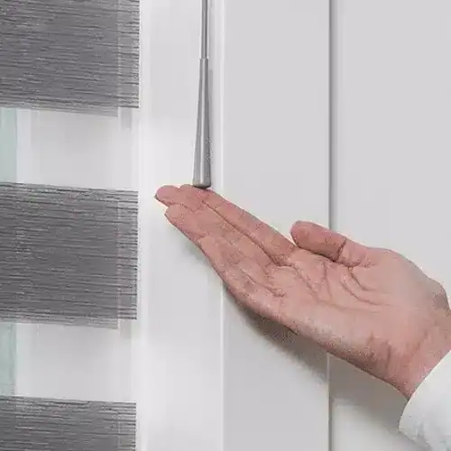Close-up of a person's hand inspecting a door gasket seal.