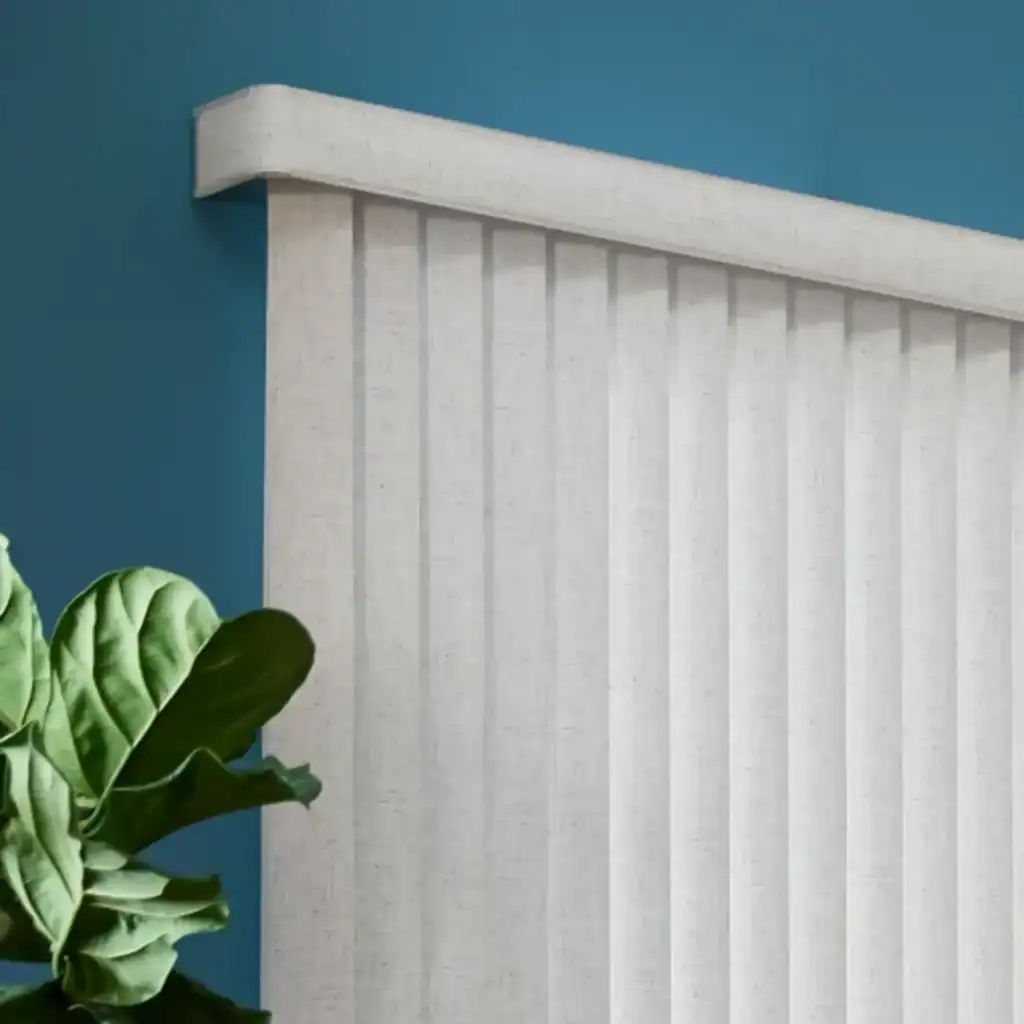 Stylish white radiator mounted on a blue wall with a lush green plant in a modern interior setting.