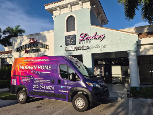 Colorful Modern Home Living delivery van parked outside Lindsey Gallery, a boutique store with a pastel blue exterior and decorative signage.